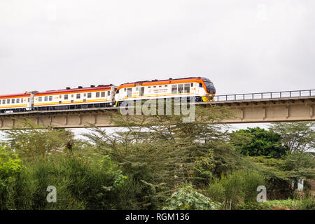 The Madaraka Express Passenger Service train travelling on a viaduct section of the Nairobi to Mombasa Standard Gauge Railway SGR, Athi River, Kenya Stock Photo