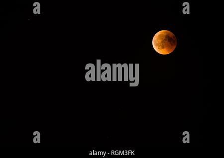 Red moon during an eclipse phase Stock Photo