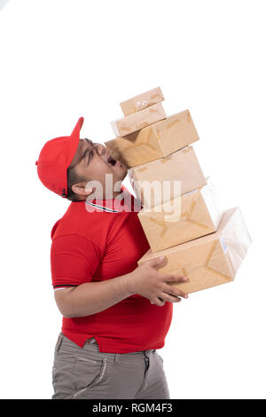 portrait of delivery man struggling to lift many boxes Stock Photo