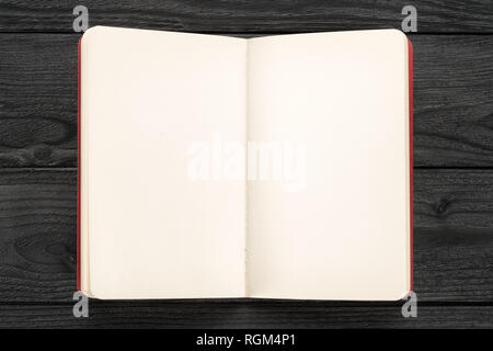 Open note on black wooden table top view. Template and background Stock Photo
