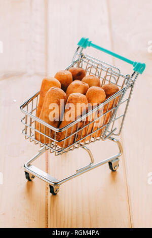 Venezuelan snack called tequeños inside a mini shopping cart Stock Photo