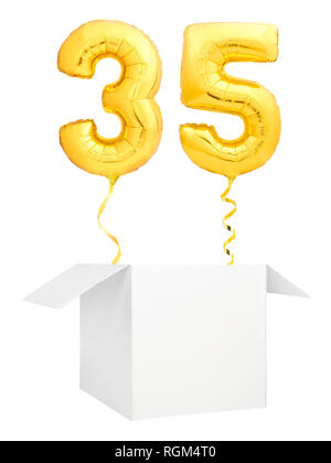 Golden number thirty five inflatable balloon with golden ribbon flying out of blank white box isolated on white background Stock Photo