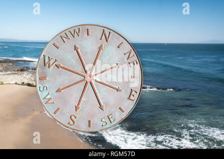 Old metal comopass isolated on ocean background Stock Photo