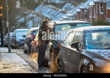 Brighton UK 30th January 2019 - Motorists clear the snow and ice from their cars in Brighton this morning as more snow and freezing conditions are forecast for the south east of Britain tomorrow Credit: Simon Dack/Alamy Live News Stock Photo