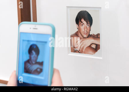 London, UK.  30 January 2019. A visitor photographs 'Sylvester Stallone' (1980). Preview of 'Andy Warhol Polaroid Pictures', an exhibition of over 60 portrait and self-portrait Polaroid photographs by Andy Warhol.  The works, which depict artists, actors, politicians and friends of his Factory entourage in New York during the 1970s and 80s, are on display 2 February to 13 April 2019 at Bastian Gallery in Mayfair.  Credit: Stephen Chung / Alamy Live News Stock Photo