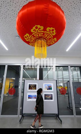 Beirut, Lebanon. 30th Jan, 2019. A visitor looks at photos during a photo exhibition commemorating the 40th anniversary of China's reform and opening-up in Beirut, Lebanon, on Jan. 30, 2019. The photo exhibition on the 40th anniversary of China's reform and opening-up, jointly held by Chinese Embassy in Lebanon and the Lebanese Academy of Fine Arts, opened here on Wednesday and will last till Feb. 2. Credit: Bilal Jawich/Xinhua/Alamy Live News Stock Photo