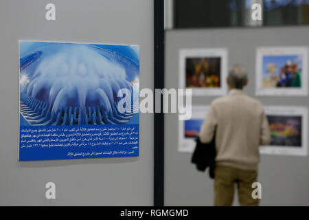 Beirut, Lebanon. 30th Jan, 2019. A visitor looks at photos during a photo exhibition commemorating the 40th anniversary of China's reform and opening-up in Beirut, Lebanon, on Jan. 30, 2019. The photo exhibition on the 40th anniversary of China's reform and opening-up, jointly held by Chinese Embassy in Lebanon and the Lebanese Academy of Fine Arts, opened here on Wednesday and will last till Feb. 2. Credit: Bilal Jawich/Xinhua/Alamy Live News Stock Photo