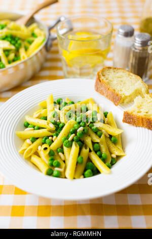 Penne with peas and pine nuts on plate Stock Photo