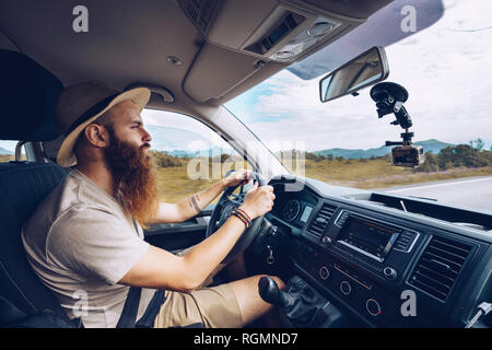 Norway, Lofoten, bearded man driving Stock Photo