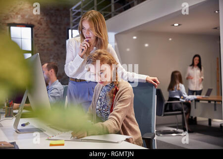 Young woman working in modern creative office, usine laptop Stock Photo