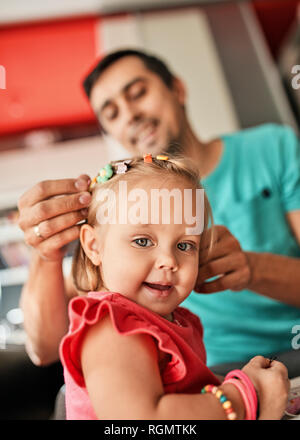 Portrait of smiling little girl with her father in the background Stock Photo