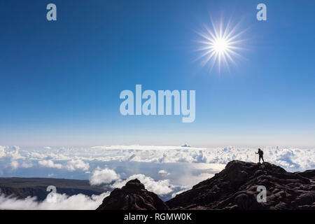 Reunion, Reunion National Park, Shield volcano Piton de la Fournaise, female tourist hiking to crater Stock Photo