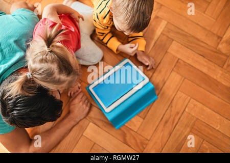 Father and his children using digital tablet at home, top view Stock Photo