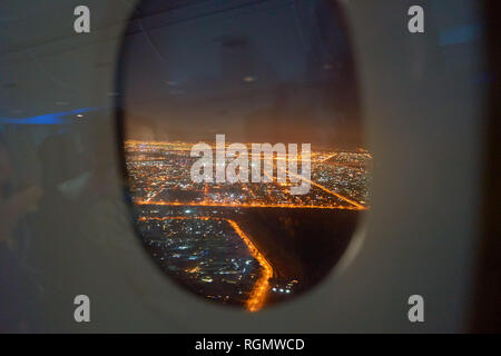 DUBAI, UAE - CIRCA NOVEMBER 2016: view of Dubai from Emirates A380 at night. Stock Photo