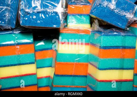 multi-colored sponges in packing in a warehouse, dishwashing sponges, wholesale sale of goods Stock Photo