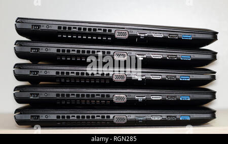 Input and connection sockets on side of laptops folded stack isolated on white background Stock Photo