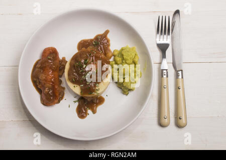 very typical irish dish, mashed potato, onion gravey, grilled sausages, mushy peas and chopped rosemary Stock Photo