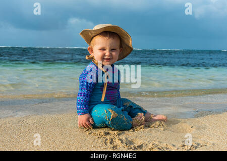 Panama, San Blas Islands, Achutupo, baby playing in the sand on beach Stock Photo