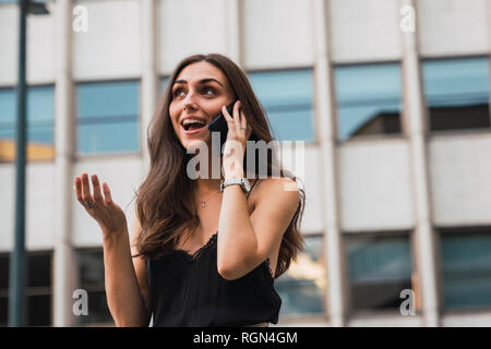 Portrait of smiling young woman on the phone Stock Photo