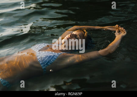 Portrait of woman floating in a lake Stock Photo