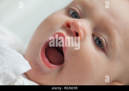 Portrait of yawning baby girl, close-up Stock Photo