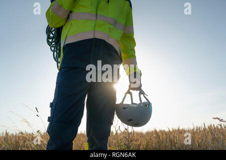 Close-up of technician in a field with climbing equipment Stock Photo