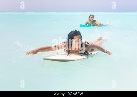 Young couple having fun at he sea, surfing Stock Photo