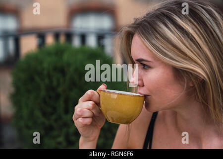 Young woman drinking cup of coffee Stock Photo