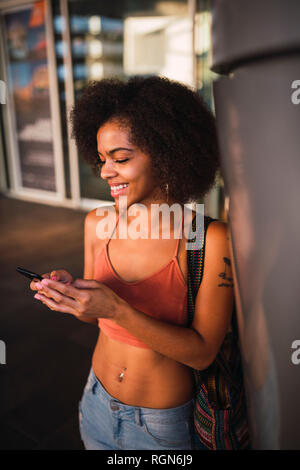 Happy young woman using cell phone Stock Photo