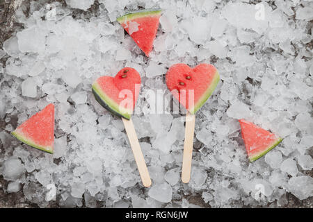 Watermelon heart ice lollies on crashed ice Stock Photo