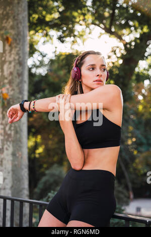 Fit young woman stretching before training Stock Photo