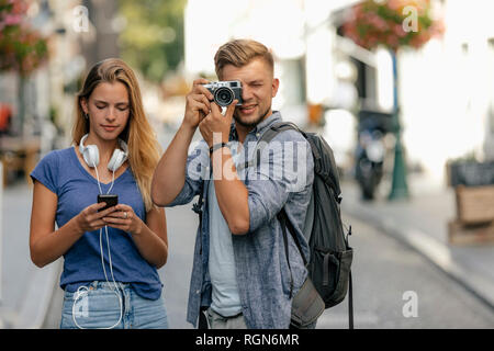 Netherlands, Maastricht, young couple exploring the city taking pictures Stock Photo