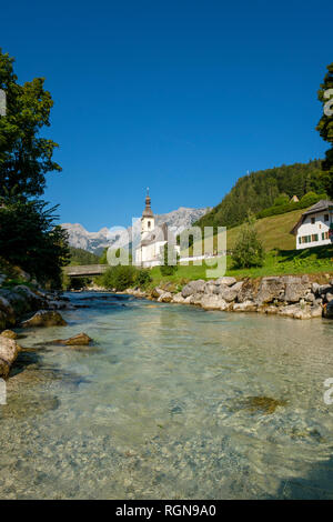 Germany, Bavaria, Berchtesgadener Land, Parish church St Sebastian in front of Reiteralpe mountain Stock Photo