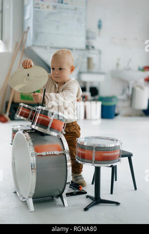 Toddler with toy drums Stock Photo