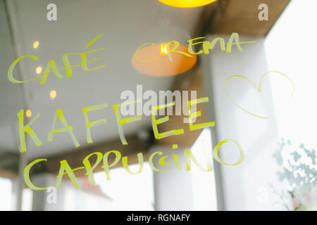 Handwritten offer on windowpane in a cafe Stock Photo