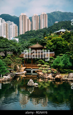 China, Hong Kong, Diamond Hill, Pond in Nan Lian Garden surrounded by skyscrapers Stock Photo