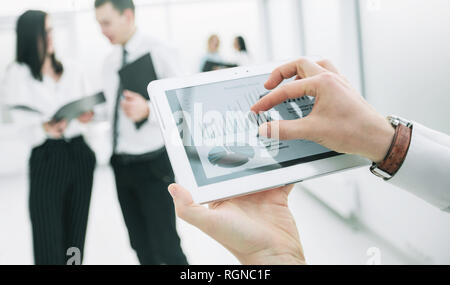 close up. digital tablet in the hands of a businessman. Stock Photo