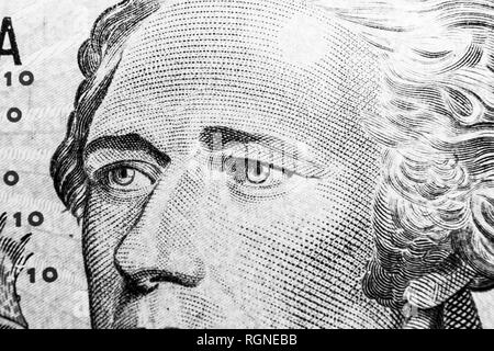 Close up view Portrait of Alexander Hamilton on the one ten dollar bill. Background of the money. 10 dollar bill with Alexander Hamilton eyes macro sh Stock Photo