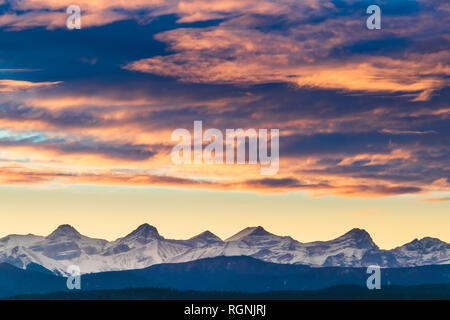 The sun sets over the foothills of Kananaskis Country in a blaze of color on a cold winter afternoon just outside the city of Calgary, Alberta, Canada Stock Photo
