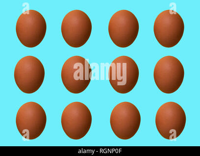 Pattern of colored chicken eggs isolated on pastel background. Top view. Minimalistic design Stock Photo