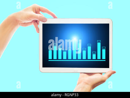 Business woman shows a tablet with a sales graph.  Profit analytics.  Financial and bank technology concept. Chart from electronic portable device Stock Photo