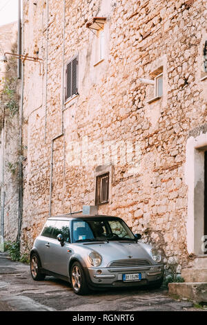Terracina, Italy - October 15, 2018: Front View Of Gray Color 2004 Mini One Hatch (pre-facelift model) Mini Cooper Car Parking On Street Near Old Ital Stock Photo