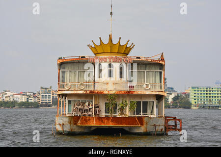 Hanoi, Vietnam - December 16th 2017. An old abandoned boat in West Lake in Hanoi. Disused for many years, the boat is now rusting in the lake. Stock Photo