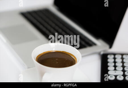 Business work place with cup of coffee calculator and Computer laptop Stock Photo