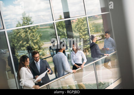 Young designers talking on break about business plans Stock Photo