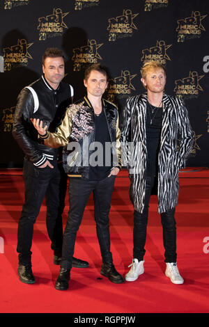 MUSE, Matt Bellamy (singer), Chris Wolstenholme (bass), Dominic Howard (drums) on the red carpet before the 20th NRJ Music Awards ceremony in Cannes ( Stock Photo