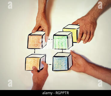 Four hands building up a connected blockchain Stock Photo
