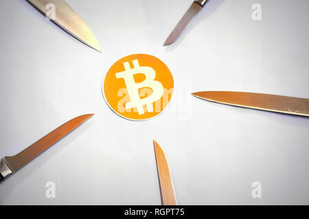 Bitcoin surrounded by five attacking knifes Stock Photo