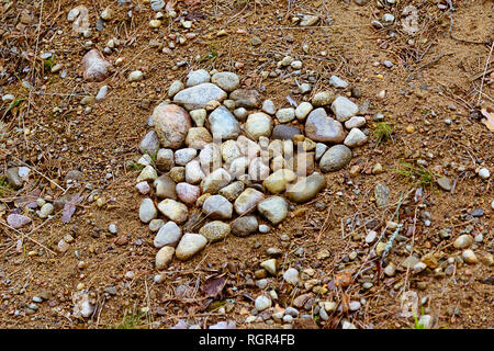 heart collected from small stones, brown red earth Stock Photo