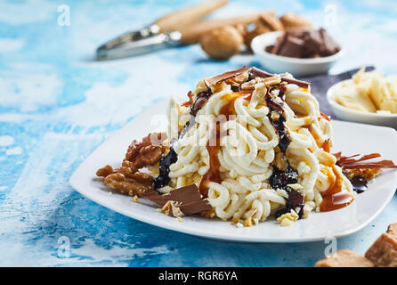 Spaghetti ice cream dessert with sweet caramel topping Stock Photo